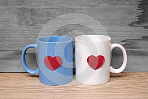 Blue and white cup with hearts on a wooden table