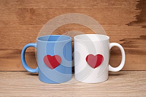 Blue and white cup with hearts on a wooden table