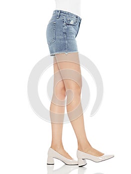 Blue and white denim ripped shorts for womenâ€™s paired with white tank top and black footwear with white background