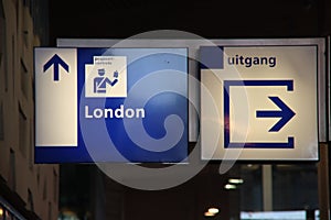 Blue and white direction sign to the passport control to london at Rotterdam station for Eurostar photo