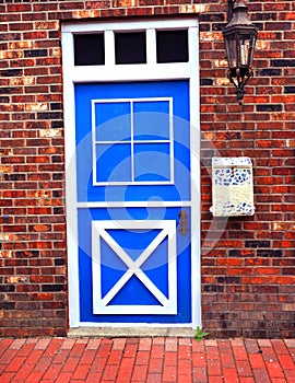 Blue and White Door in Brick Wall