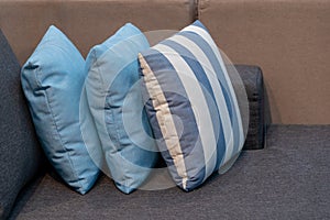 Blue and white fabric pillow on brown fabric cushion sofa interior decoration