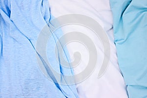 Blue and white fabric top view photo. Gentle colored textile photo texture. Folded fabric with wrinkles for pattern mockup. Blank