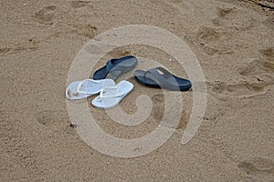 BLUE AND WHITE FLIPFLOPS ON THE SAND