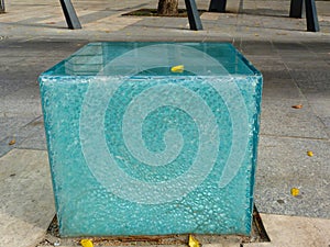 Blue and white glass seat on public street with shattered side