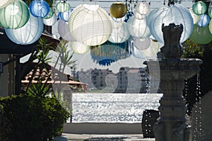 Blue, white,  and green lanterns framing harbor near Seaport Village during Christmas season