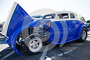 Blue and white hot rod with chrome engine