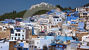 Blue and white houses on the side of a hill
