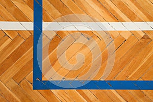 Blue white lines. Worn out wooden floor of sports hall with colorful marking lines.