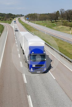 Blue and white lorry on highway