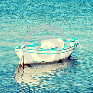 Blue and white old wood boat at a Mediterranean sea(Greece)