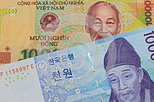 A blue and white one thousand won bill from Korea paired with a colorful, plastic ten thousand dong note from Vietnam.