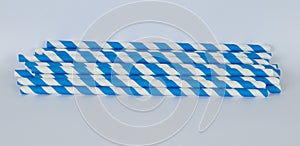 Blue and white paper straws in a horizontal format on a white background photo