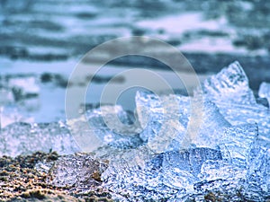 Blue and white pieces of broken ice. Melting of broken ice pieces, crushed floes photo