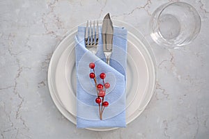 Blue and white place setting with red berries