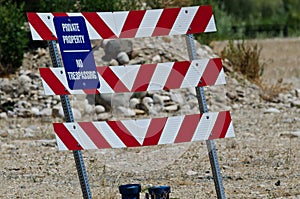 Blue and White Private Property Sign on Construction Barricade