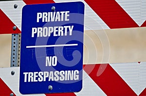 Blue and White Private Property Sign on Construction Barricade
