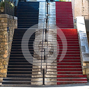 Blue, white and red French flag on a staircase in Valbonne on the French Riviera