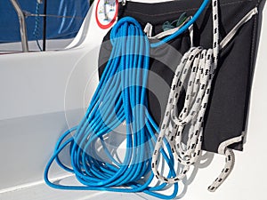 Blue and white ropes on the yacht. Orderly and ready to use