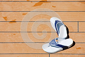 Blue and White Sandles on a Wood Deck