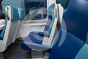 Blue and white seats inside a train car