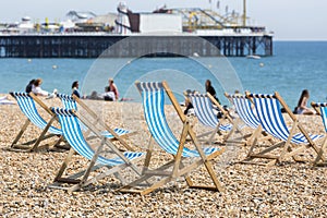 Blue and white striped deckchairs on Brighton beach