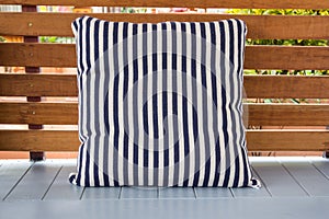Blue and white striped pillow on terrece