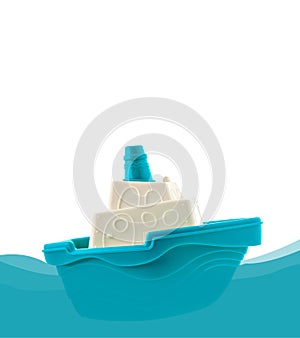 Blue and white toy boat floating on the waves