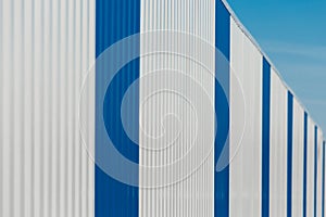 Blue and white vertical lines sheet metal plate corrugated texture steel fence background
