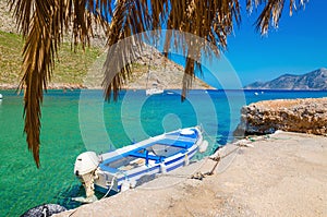 Blue and white wooden boat in cosy Greek port photo