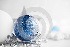 Blue and white xmas ornaments on glitter holiday background. Merry christmas card.