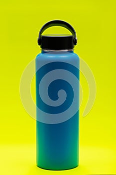 Blue Wide Mouth Insulated Stainless Steel Bottle with Wide Flat Cap isolated on bright yellow. BPA-Free. Double Wall Va