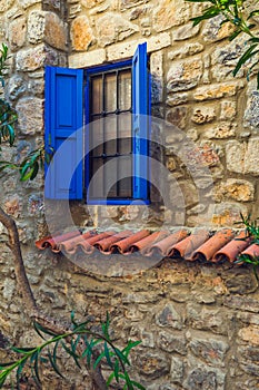 Blue window in an old stone house
