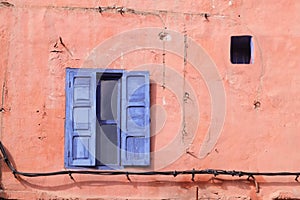 Blue window on the pink wall.