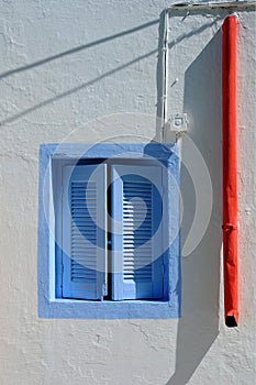 Blue Window and Red Rainwater Pipe
