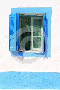 Blue window with shutters on Greek Island