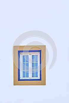 Blue window on a white wall in Morocco