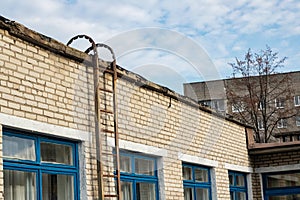 Blue windows of brick building and staircase to roof