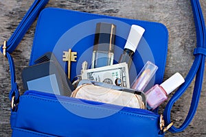 Blue women's purse. Things from open lady hand bag..