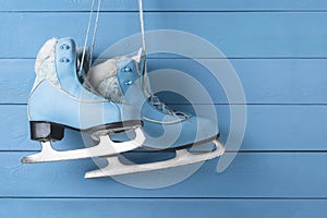 Blue women skates on a wooden wall