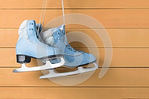 Blue women skates on a wooden wall