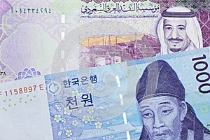 A blue won note from South Korea with a five riyal note from Saudi Arabia photo