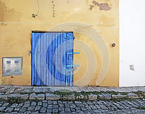 Blue wood door on rustic yellow wall photo