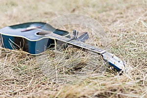 Blue Wooden acoustic guitar on grass