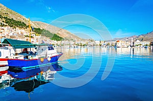 Blue wooden boat moored in peaceful port