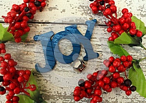 Blue wooden Christmas tree decoration spelled out Joy