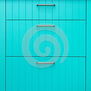 Blue wooden facade of kitchen cabinets