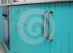 Blue wooden facade of kitchen cabinets