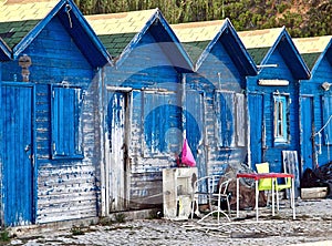 Blue wooden fisher houses in Olhos de Agua in Portugal photo