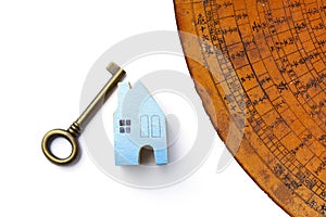 Blue wooden miniature house and antique key with old Chinese Feng Shui compass plate